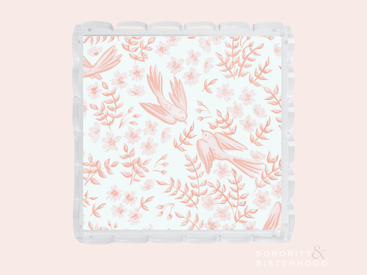 Clear scalloped tray with coral pink floral and bird pattern on white background.