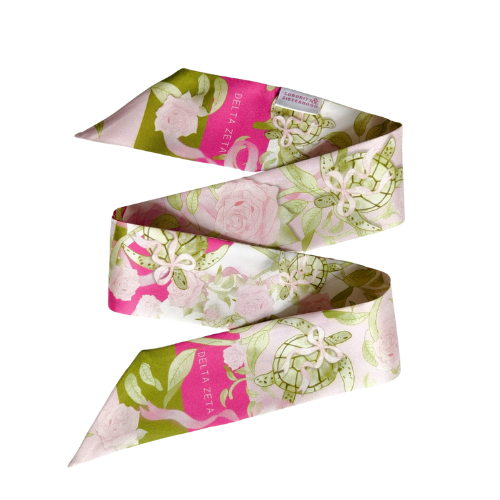 Floral scarflette with pink, white, and green pattern and Delta Zeta crest accents.