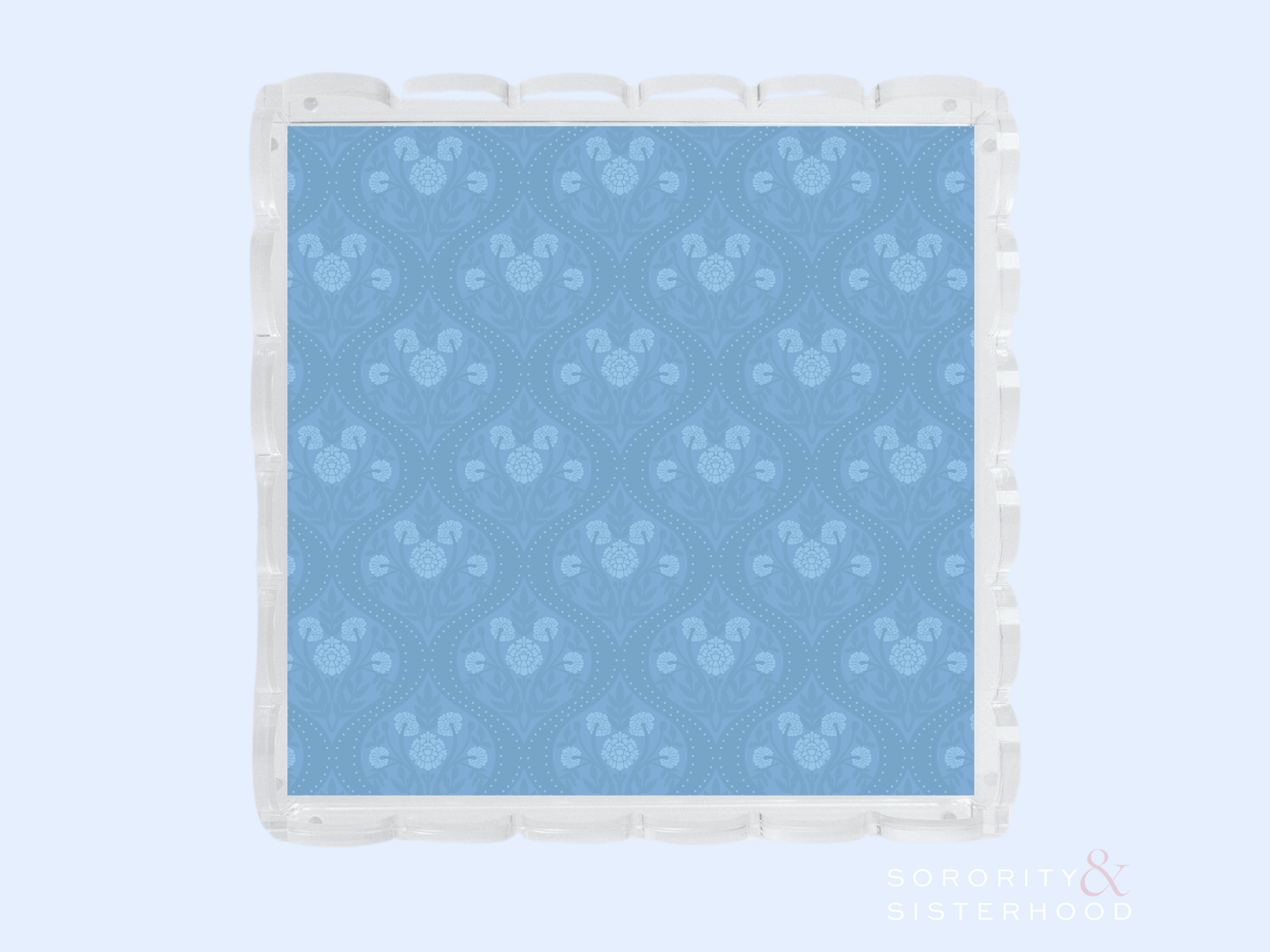 Blue acrylic tray with scalloped edges and subtle floral pattern embossed on surface.