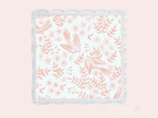 Clear scalloped tray with coral pink floral and bird pattern on white background.