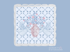 White acrylic tray with scalloped edges and blue plaid pattern, featuring pink floral arrangement and greenery design in the .