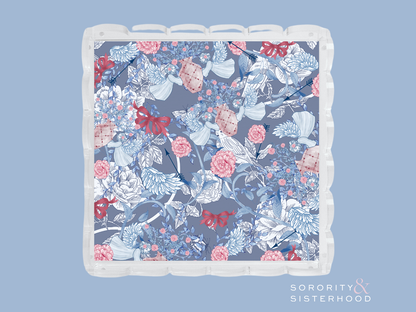 Acrylic tray with scalloped edges featuring a blue floral pattern with pink and red accents.