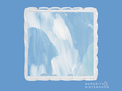 Square ceramic tray with blue and white abstract brush strokes and scalloped edges.