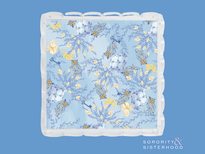 Light blue tray with scalloped edges and delicate yellow and white floral pattern.