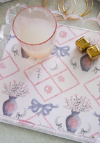 Rectangular tray with scalloped edges, decorated with blue bows, pink florals in blue vases, and geometric patterns on white .