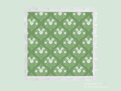 Green acrylic tray with white scalloped edges and a repeating white floral pattern.