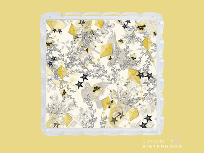 White tray with scalloped edges decorated with gold and black Kappa Alpha Theta sorority symbols and floral accents.