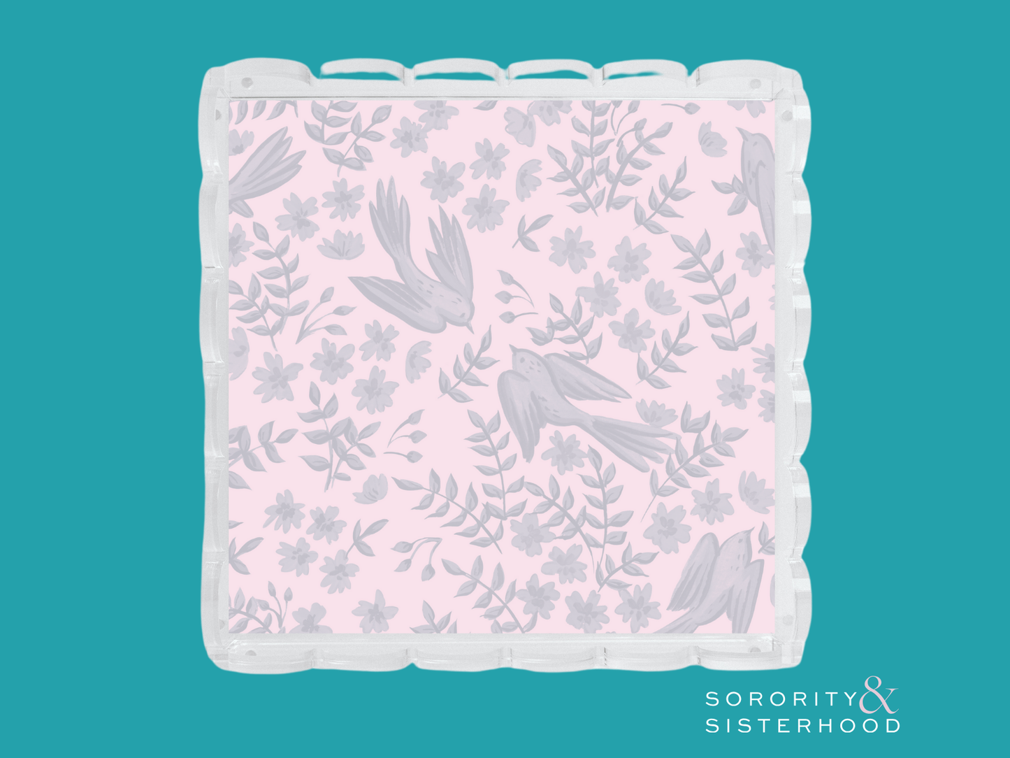 Pink acrylic tray with scalloped edges and light gray floral and bird pattern.