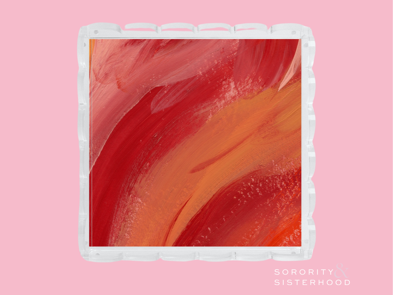 Square clear acrylic tray with scalloped edges and red-orange abstract swirl design center.