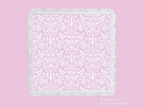 Lavender scalloped tray with white damask pattern and glossy scalloped edges.