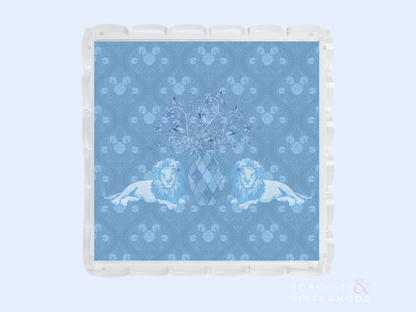 Clear acrylic tray with scalloped edges featuring a blue patterned insert with two lions and a central crest design.
