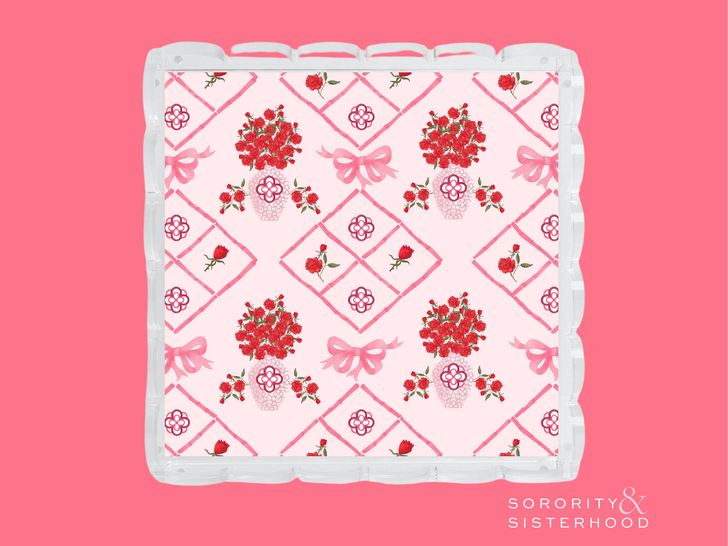 Pink and white acrylic tray with scalloped edges and red floral diamond pattern.