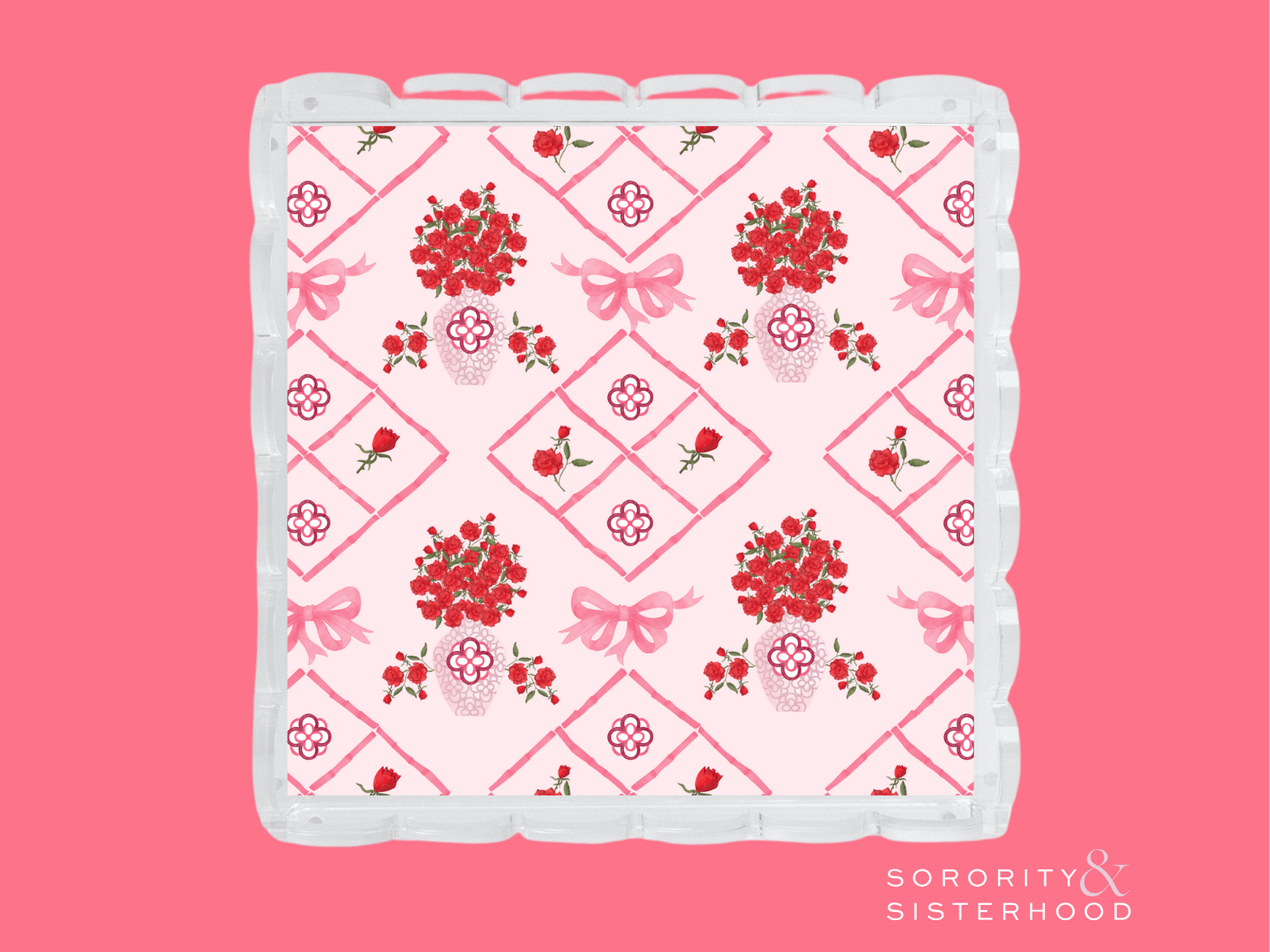 Pink and white acrylic tray with scalloped edges and red floral diamond pattern.
