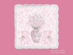 Clear acrylic tray with scalloped edges, pink floral background, and teddy bears holding a ribboned vase illustration.