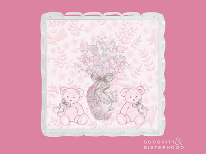 Clear acrylic tray with scalloped edges, pink floral background, and teddy bears holding a ribboned vase illustration.