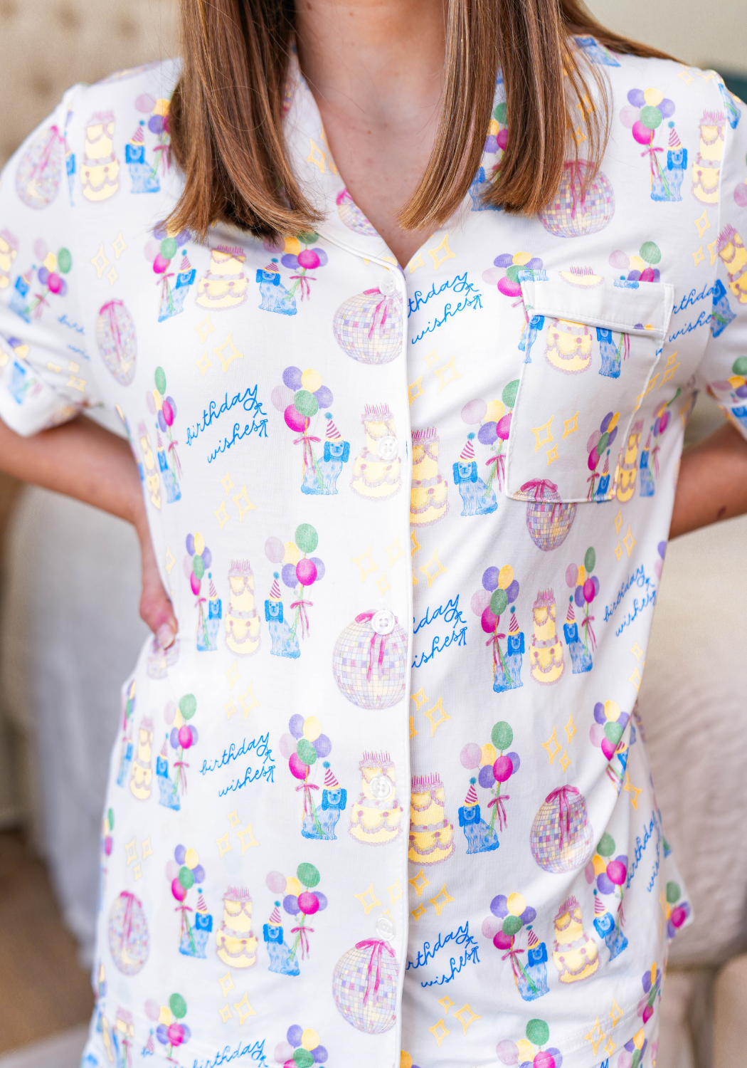 White button-up pajama top with colorful birthday-themed prints including cakes, balloons, and gifts.