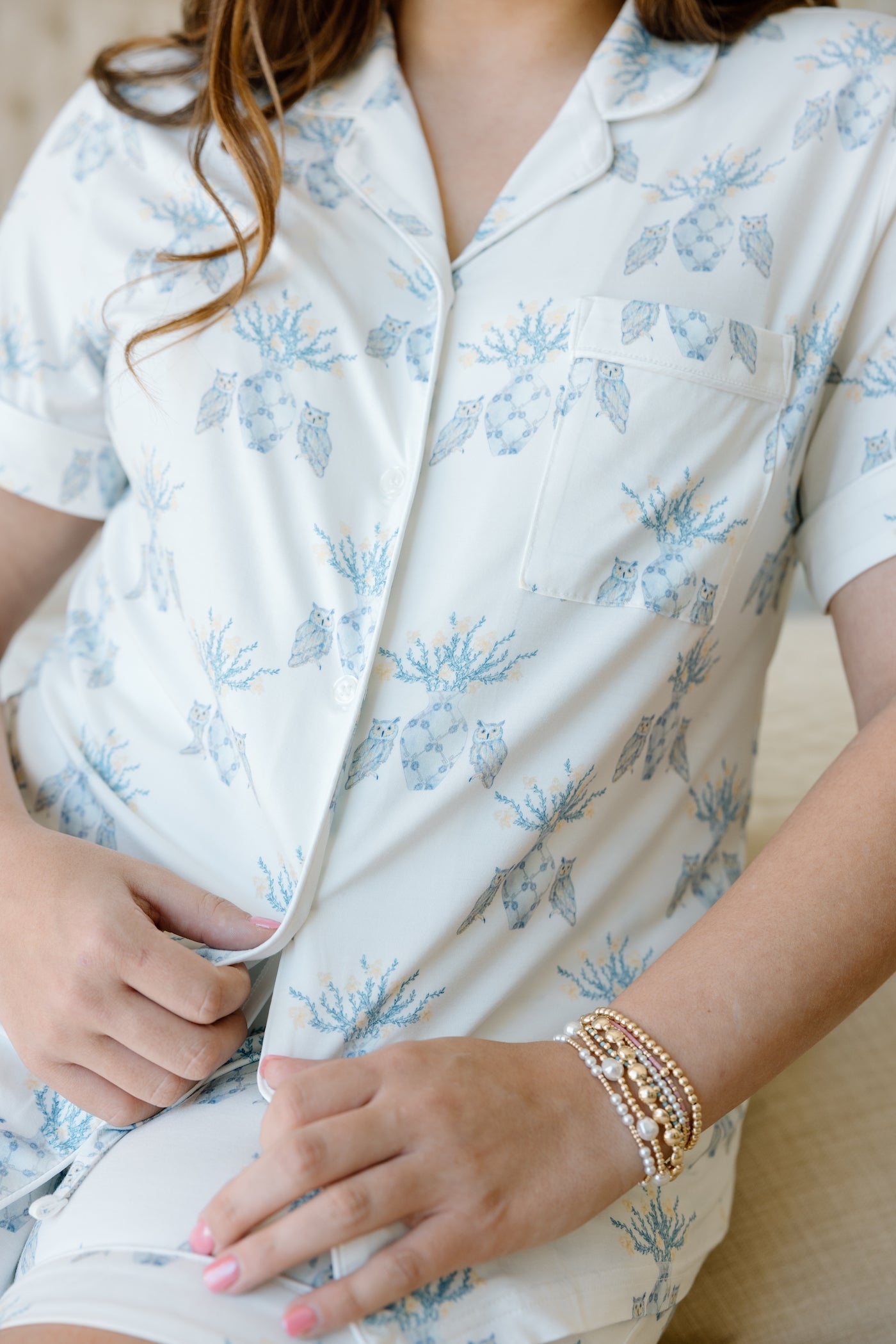 White pajama shorts set with light blue floral print, short sleeves, and button-up front.