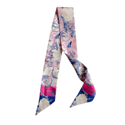 Silk scarflette with pink, blue, and cream floral print and deep pink border accents.