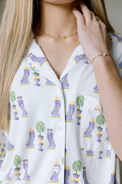 White pajama top with colorful Mardi Gras mask and bead prints, button-up style.