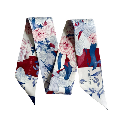 Silk scarflette with floral and bird print in blue, pink, red, and white colors.