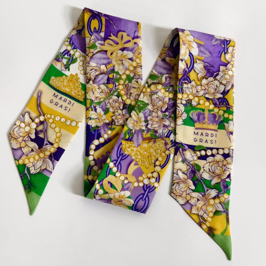Purple, green, and gold Mardi Gras scarf with floral and bead designs and "Mardi Gras!" text.